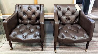 CLUB ARMCHAIRS, a pair, each 65cm W x 75cm H, in buttoned brown leather on turned supports,