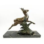 A SOLEALL BRONZE DEER, Art Deco on black variegated marble base, 52cm L x 41cm H.