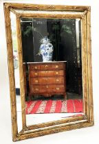 WALL MIRROR, late 19th century French giltwood and gesso with reeded and floral cushion frame,