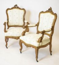 FAUTEUILS, 105cm H x 64cm W, a pair, late 19th century French walnut and gilt heightened in cream