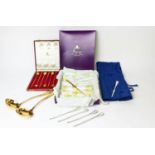 AN ASPREY SILVER GILT SET, of six stirring spoons, boxed, a set of twelve German lobster picks,