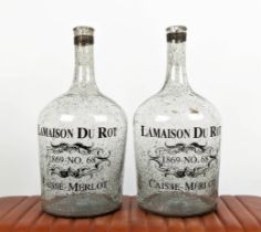 BOTTLES, a pair, 51cm H, aged clear glass, stamped La Maison Du Pont, 1969 No. 68, Caisse Merlot. (