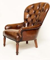 ARMCHAIR, early 20th century library style deep buttoned mid brown leather upholstered with turned