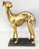 SCULPTURAL WHIPPET, gilt resin, raised on a black plinth, 64cm x 43cm x 15cm.