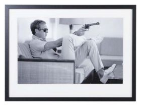 AFTER JOHN DOWNING, Steve McQueen with a gun, photographic print, framed and glazed, 54cm x 74cm.