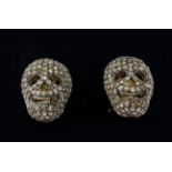 A PAIR OF SILVER-GILT MEMENTO MORI-STYLE SKULL CUFFLINKS, with pave set rose cut diamonds,