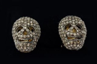 A PAIR OF SILVER-GILT MEMENTO MORI-STYLE SKULL CUFFLINKS, with pave set rose cut diamonds,