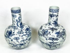 CHINESE BLUE AND WHITE VASES, a pair, painted with dragons chasing the flaming pearl of wisdom, 63cm