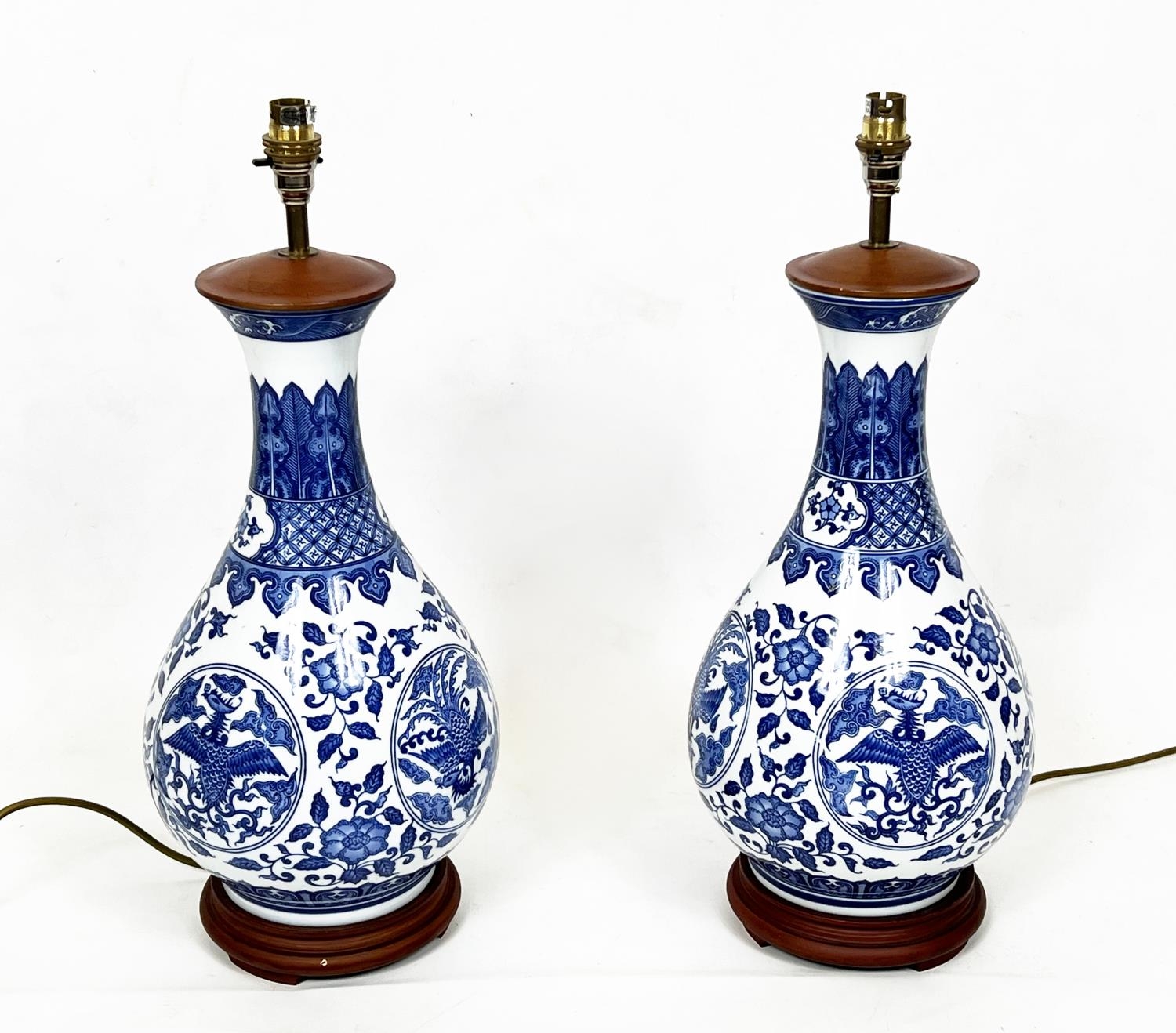 CHINESE BOTTLE LAMPS, a pair, blue and white with scrolling foliate and phoenix decoration, 56cm