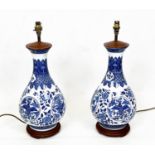 CHINESE BOTTLE LAMPS, a pair, blue and white with scrolling foliate and phoenix decoration, 56cm