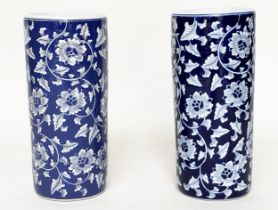 STICK STANDS, a pair, Chinese blue and white ceramic, cylindrical with indigo blue ground, 45cm. (2)