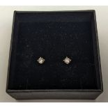 A PAIR OF 18CT WHITE GOLD DIAMOND SOLITAIRE STUD EARRINGS, the round brilliant cut stones of a total