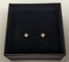 A PAIR OF 18CT WHITE GOLD DIAMOND SOLITAIRE STUD EARRINGS, the round brilliant cut stones of a total