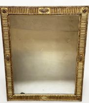 WALL MIRROR, 19th century giltwood and gesso moulded with bevelled plate, rosette cornered and
