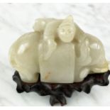 CHINESE PALE CELEDON JADE CARVED ELEPHANT AND BOY, 9cm L x 8cm H.