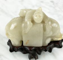 CHINESE PALE CELEDON JADE CARVED ELEPHANT AND BOY, 9cm L x 8cm H.