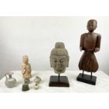 A CARVED STONE BUDDHA HEAD ON STAND, an Oriental wood figure and a glazed pottery figure along