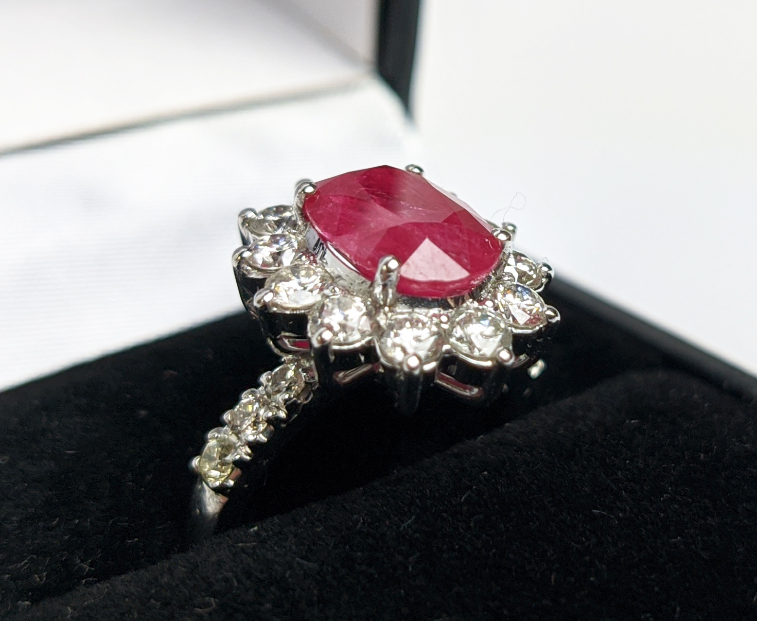 AN 18CT WHITE GOLD RUBY AND DIAMOND CLUSTER RING, with diamond set shoulders, the central oval cut - Image 3 of 10