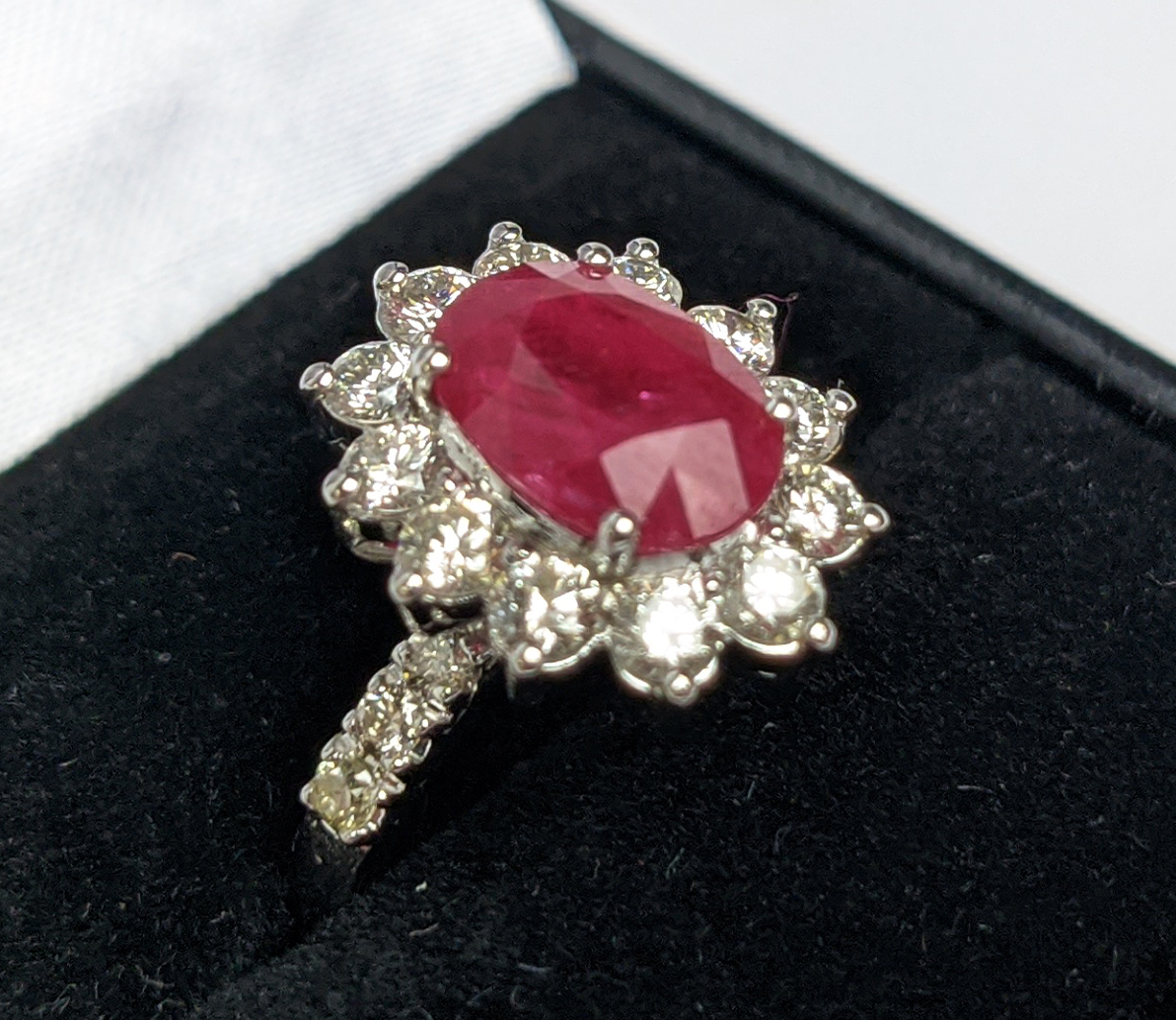 AN 18CT WHITE GOLD RUBY AND DIAMOND CLUSTER RING, with diamond set shoulders, the central oval cut - Image 2 of 10