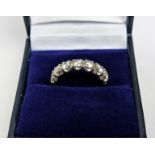 AN 18CT GOLD DIAMOND HALF ETERNITY RING, set with seven round brilliant cut diamonds, claw set in