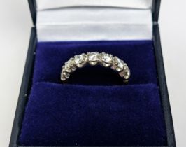 AN 18CT GOLD DIAMOND HALF ETERNITY RING, set with seven round brilliant cut diamonds, claw set in