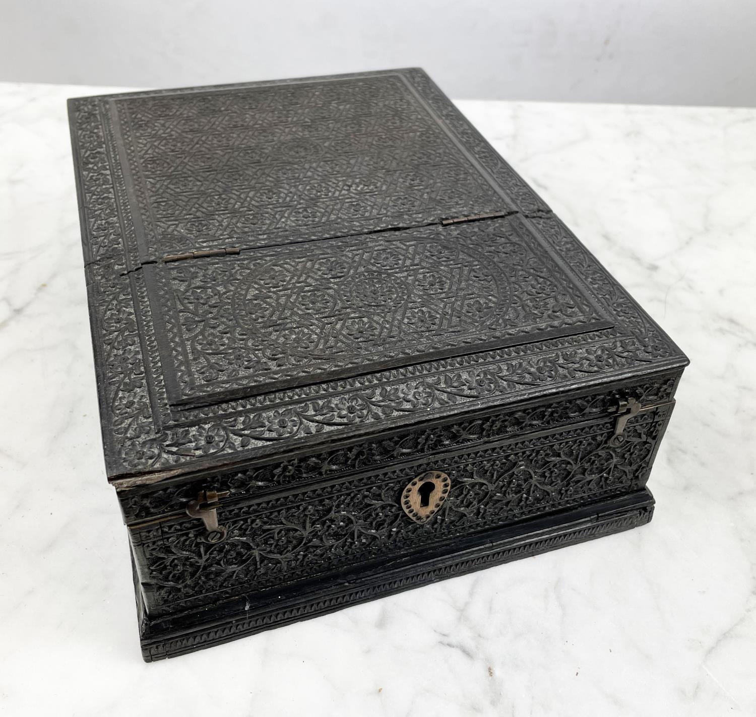 JEWELLERY BOX, 19th century Anglo-Indian ornately carved ebony with hinged lid and fitted