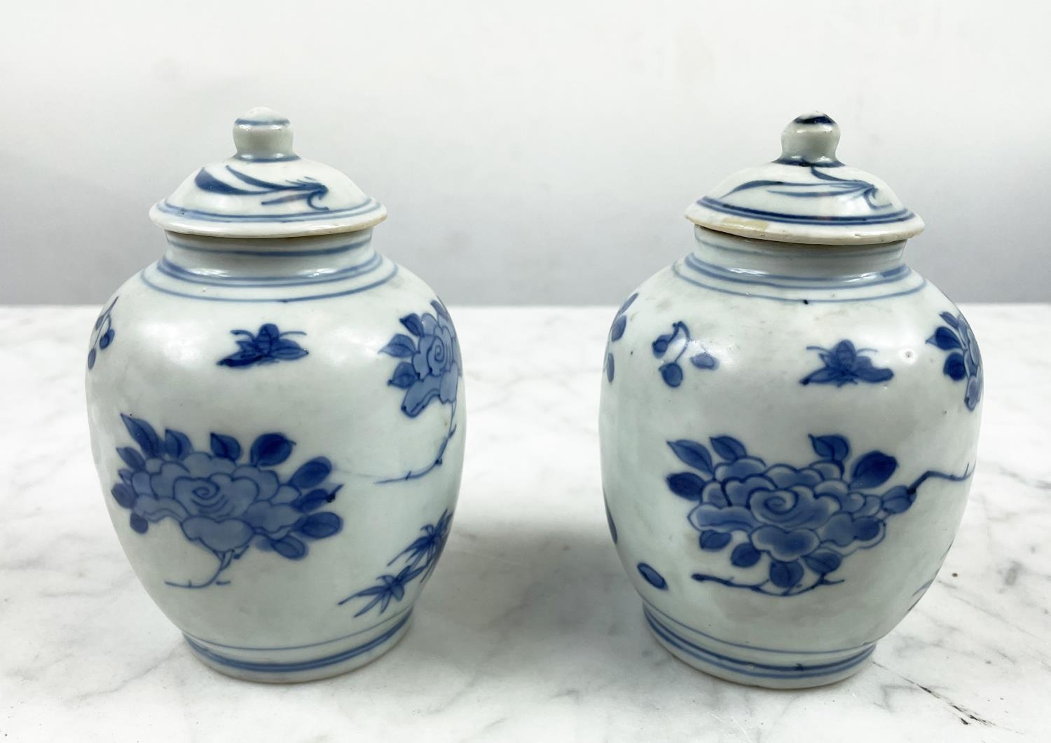 HATCHER CARGO SMALL LIDDED VASES, a pair, in blue and white foliate decoration, 13cm H. (2)