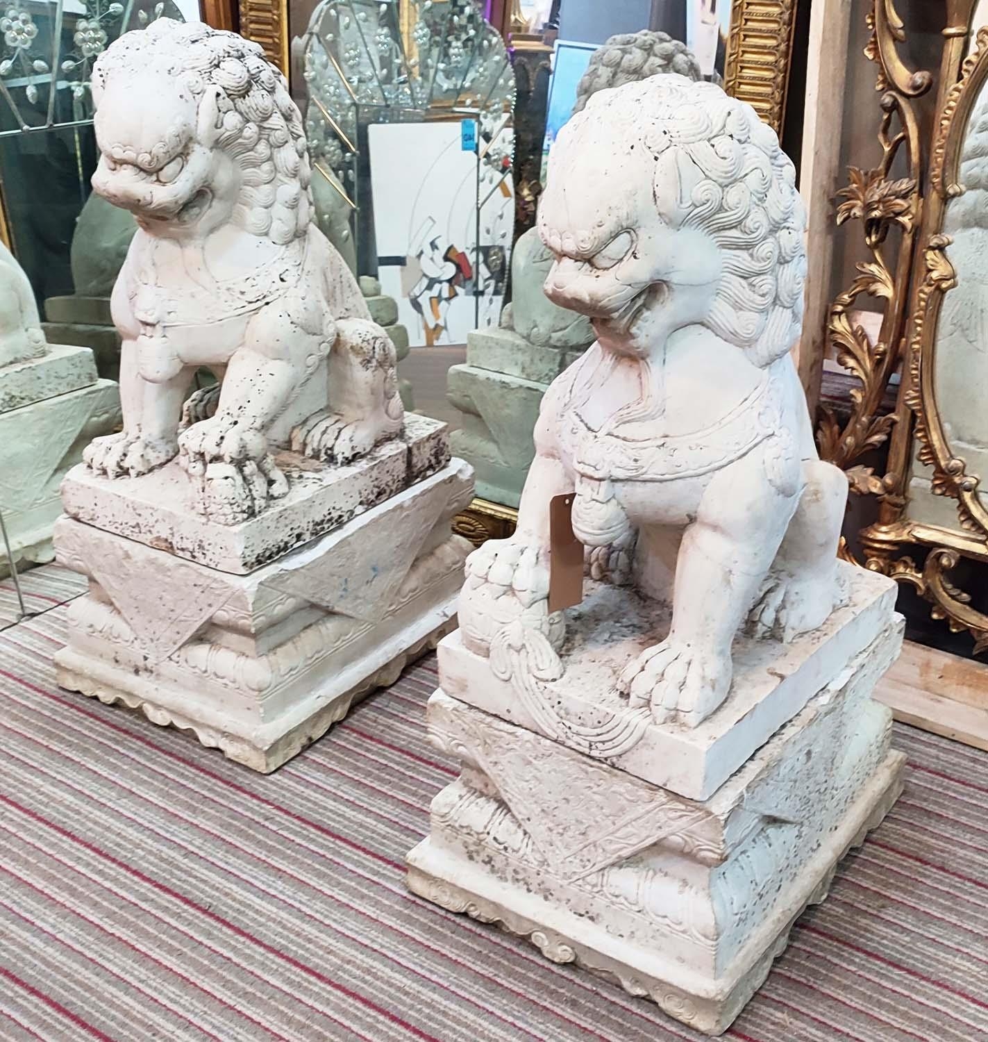 MARBLE GARDEN FOO LIONS, a pair, early 20th century on plinths, 102cm H x 58cm D x 45cm W. (2)