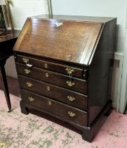 BUREAU, George II, oak, circa 1750, the fall front opening to reveal fitted interior, over four long