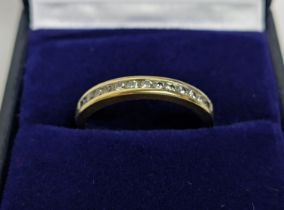 AN 18CT GOLD DIAMOND SET HALF ETERNITY RING, set with thirteen channel set brilliant cut diamonds,