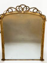 WALL MIRROR, English giltwood and gesso, arched with rope twist scrolling crest and frame, 141cm H x