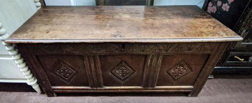 COFFER, 132cm W x 46cm D x 58cm H, Charles II oak with a rising lid and three carved front panels.