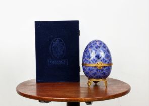 FABERGE EGG, limoges royal blue and gilt porcelain hinged lid opening to reveal musical glass