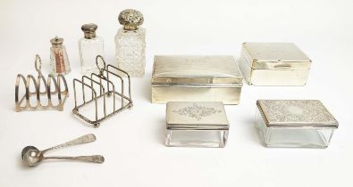 A COLLECTION OF SILVERWARE, comprising two cigarette boxes, two silver topped glass boxes, two toast