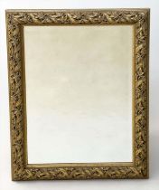 WALL MIRROR, rectangular gilt composition with bevelled mirror and foliate and strap frame, 'Skopos,