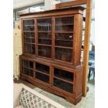 DRESSER, 215cm x 29cm x 212cm H, 20th century teak in two parts with glazed doors enclosing shelves.