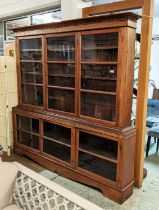 DRESSER, 215cm x 29cm x 212cm H, 20th century teak in two parts with glazed doors enclosing shelves.