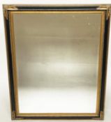 WALL MIRROR, Italian style rectangular ebonised with bevelled mirror, gilt slip and gilt corners,