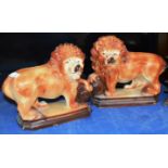 PAIR OF POTTERY LION ORNAMENTS