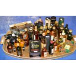 A TRAY WITH ASSORTED WHISKY & ALCOHOL MINIATURES