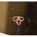 18 CARAT GOLD RING SET WITH A RUBY & DIAMOND CHIP SURROUND - APPROXIMATE WEIGHT = 3 GRAMS