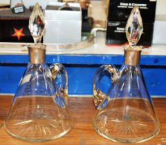 PAIR OF SILVER MOUNTED GLASS DECANTERS WITH STOPPERS