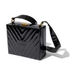 Chanel: A black patent leather hinged box bag