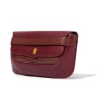 Cartier: A maroon leather clutch bag