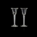 NEAR PAIR OF GEORGIAN STYLE OPAQUE TWIST CORDIAL GLASSES AND A PLAIN STEM GOBLET 20TH CENTURY