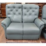 A green leather two-seater sofa with fire label.