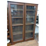 A large bookcase with lockable doors and four removal shelves. 155cm x 104cm x 37cm.