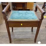 A piano stool with lift-up seat for storage of music sheets.