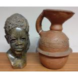 A Carved hardstone African Bust of a Female Head. Circa 1950. 18cm high. And an Earthenware Jug.