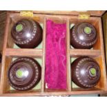 A set of four Henselite super grip indents outdoor grass bowls, size 6 in a wooden case, and two
